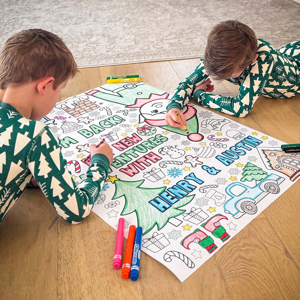 elf arrival ideas, elf arrival banner, elf on the shelf, elf on the shelf arrival banner, elf banners, elf welcome back coloring banner, giant coloring sheet, giant coloring banner, big ideas for elf arrival, grand entrance kids activity, welcome back elf arrival banner, elf kit, two children coloring a large sheet of paper on the floor with coloring markers and crayons