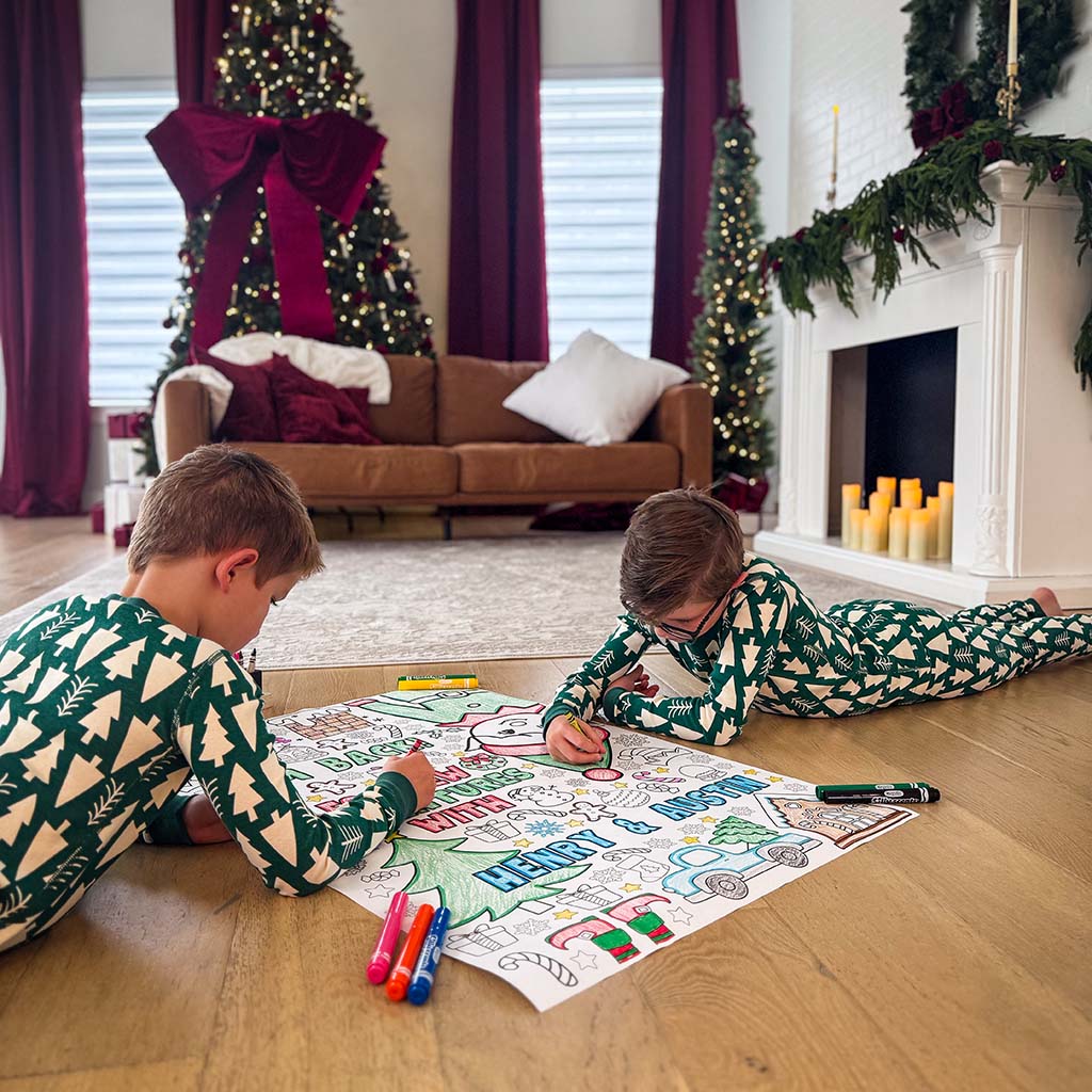 elf arrival ideas, elf arrival banner, elf on the shelf, elf on the shelf arrival banner, elf banners, elf welcome back coloring banner, giant coloring sheet, giant coloring banner, big ideas for elf arrival, grand entrance kids activity, welcome back elf arrival banner, elf kit, two children coloring a large sheet of paper on the floor with coloring markers and crayons